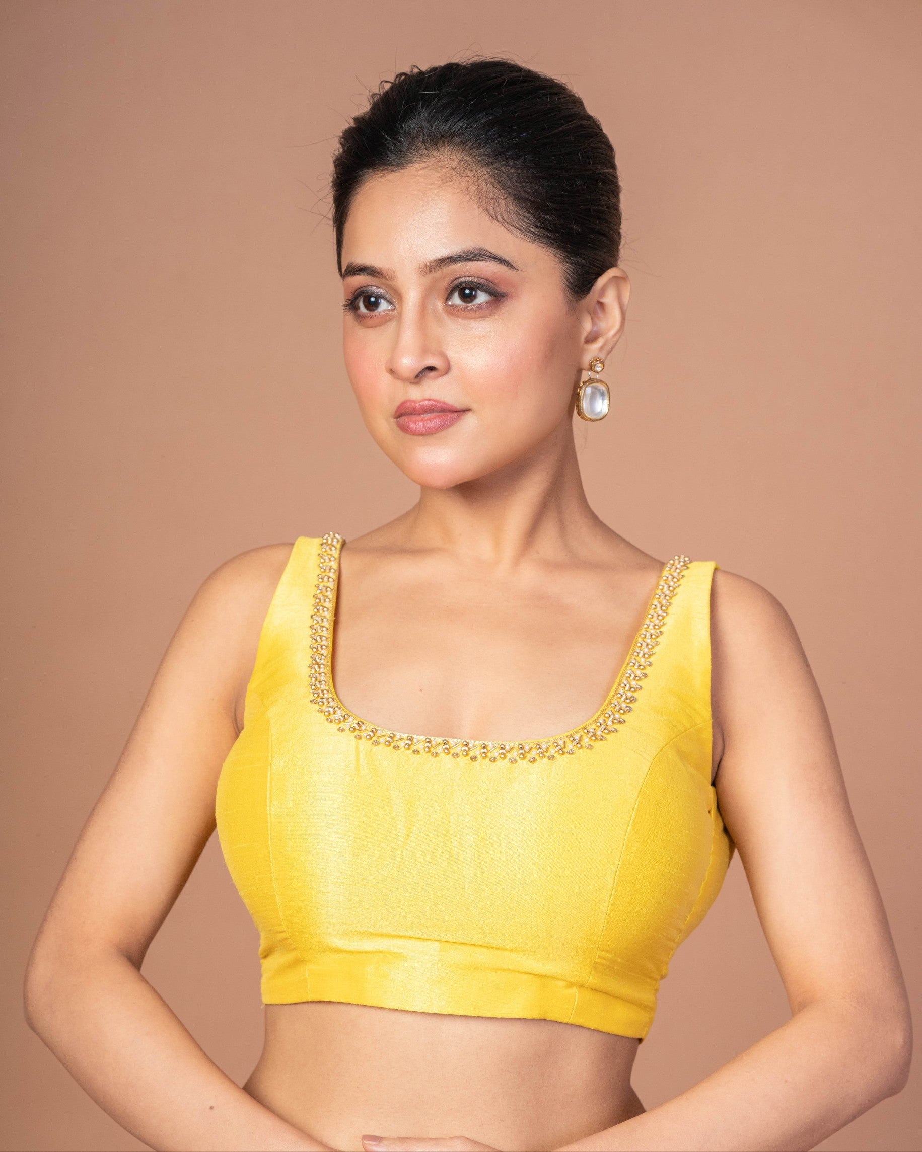 A Woman Wearing a Yellow Raw Silk Cut Dana Embroidered U Neck Sleeveless Blouse: Anvi Couture - Image 1