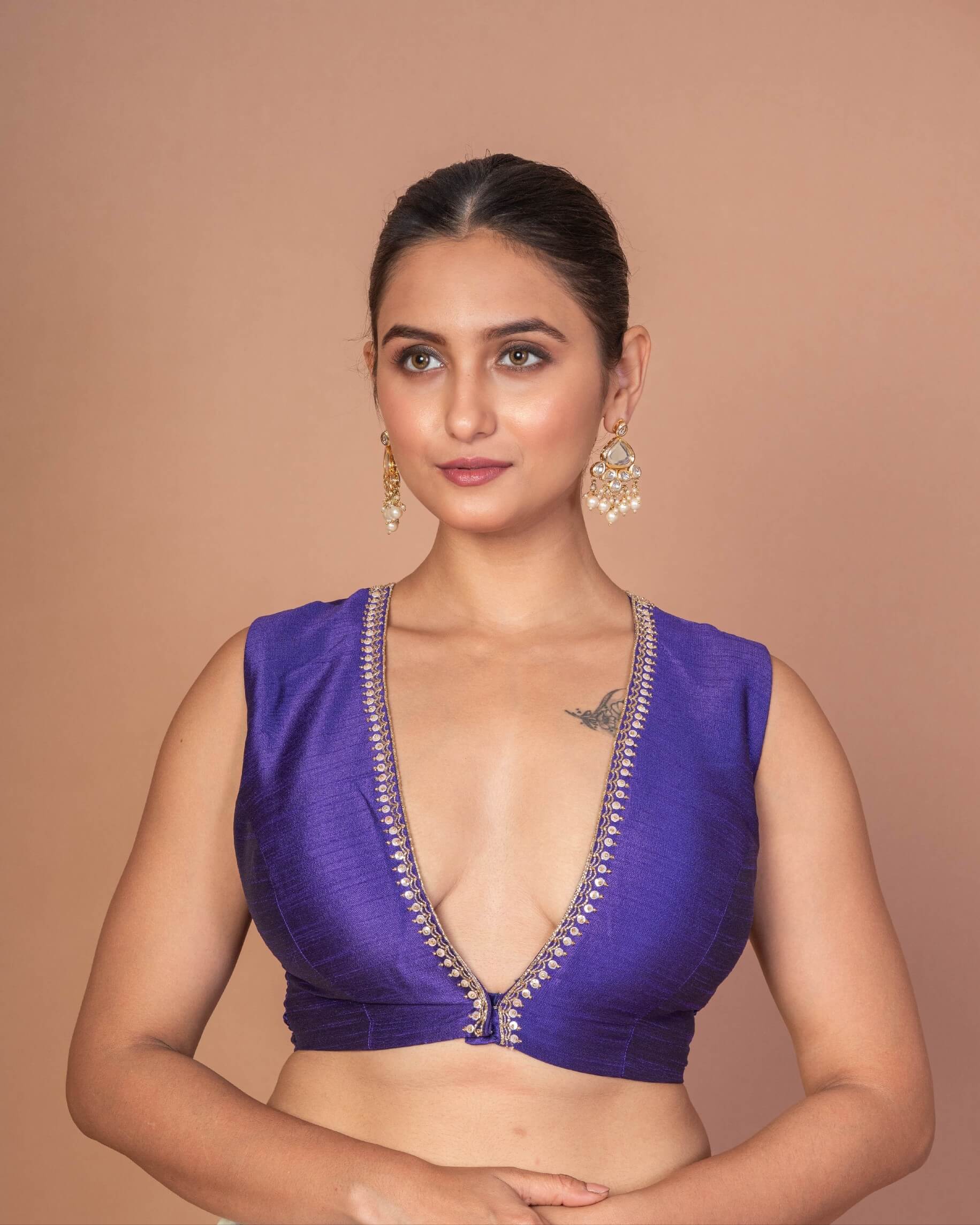 Woman Wearing a Royal Blue V-Neckline Sleeveless Blouse with Embroidered Work: Festive Wear Blouse - Anvi Couture - Image 1