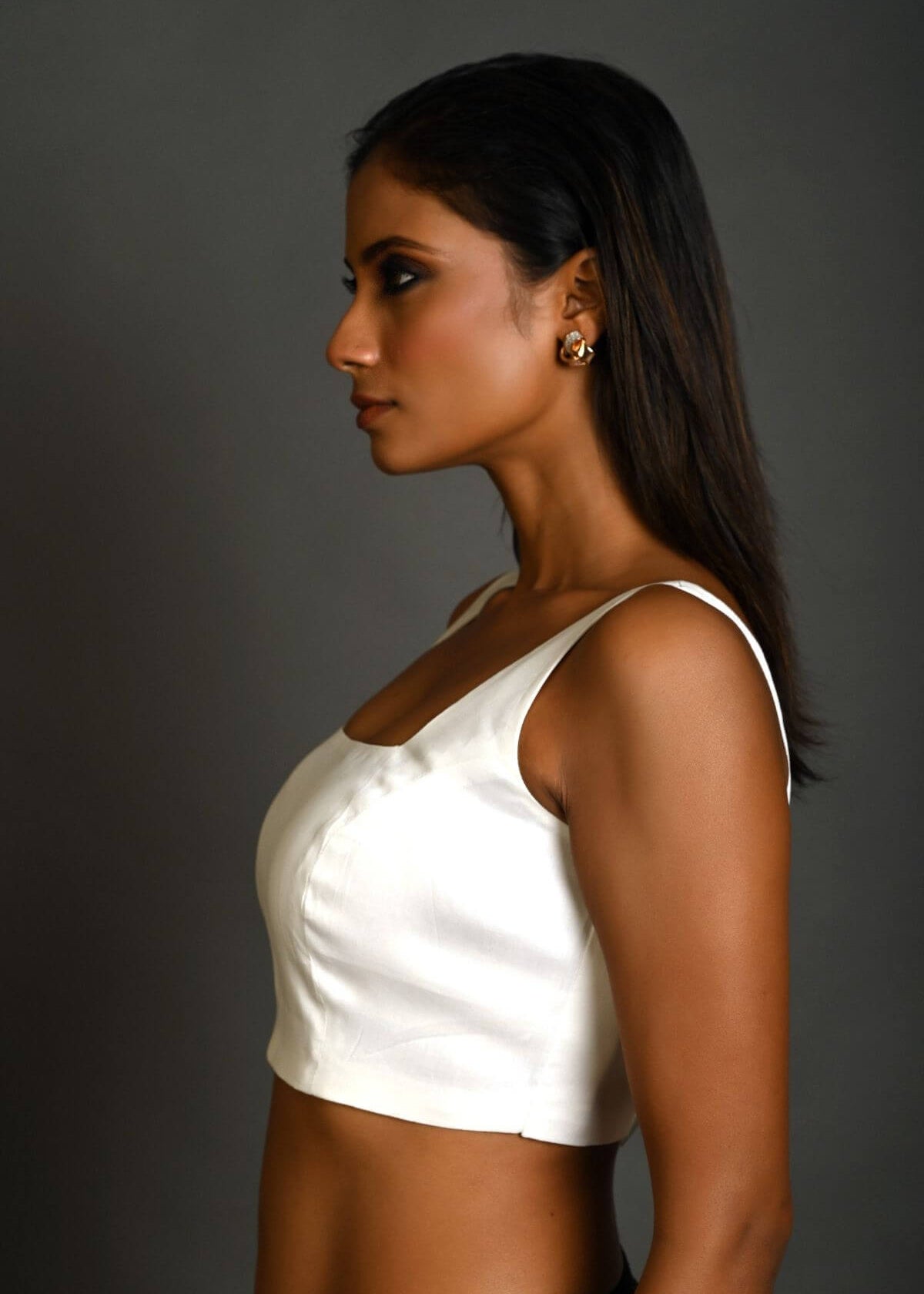 Close-up of square neckline design on white sleeveless cotton blouse