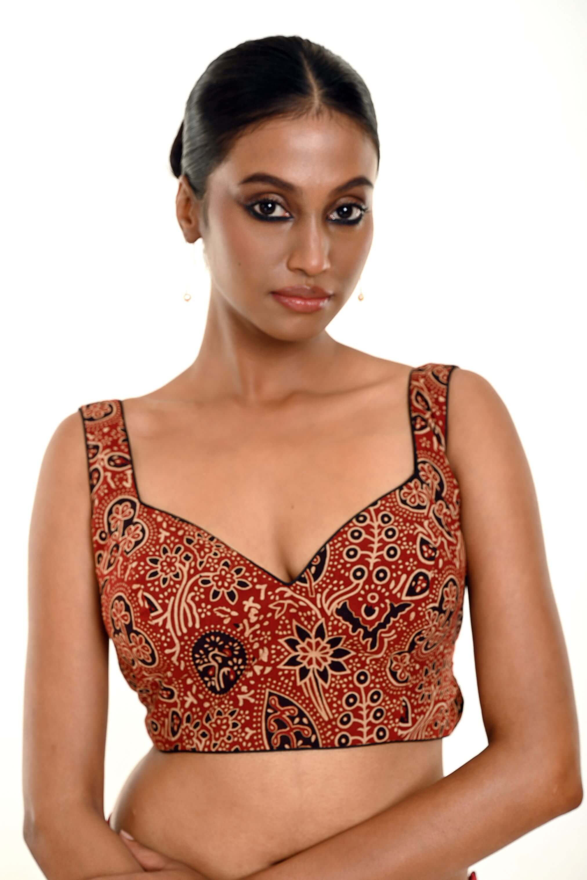 A Woman Wearing a Maroon Ajrakh Pure Cotton Sleeveless Blouse with Sweetheart Neckline - Anvi Couture - Image 1
