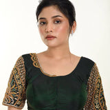 A Woman Wearing a Green Bridal Blouse in Pure Silk with Maggam Zardozi Work: Bridal Blouse - Anvi Couture - Image 1