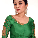 A Woman Wearing a Simple Aari Work Blouse in Green Color Pure Silk Fabric - Anvi Couture - Image 1