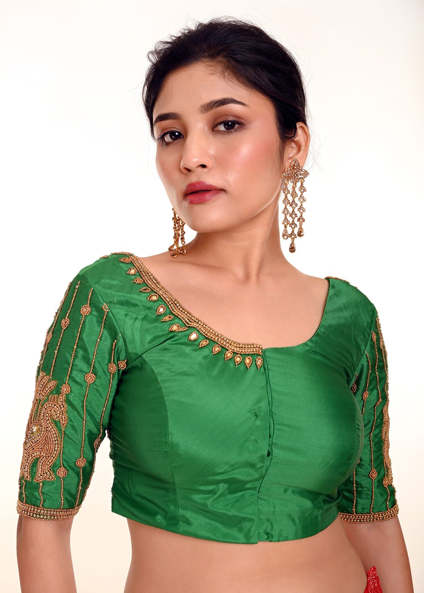 A Woman Wearing a Simple Aari Work Blouse in Green Color Pure Silk Fabric - Anvi Couture - Image 1