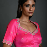 A Woman Wearing a Bright Pink Hand Embroidered Bridal Blouse in Raw Silk with Queen Anne Neckline - Anvi Couture - Image 2
