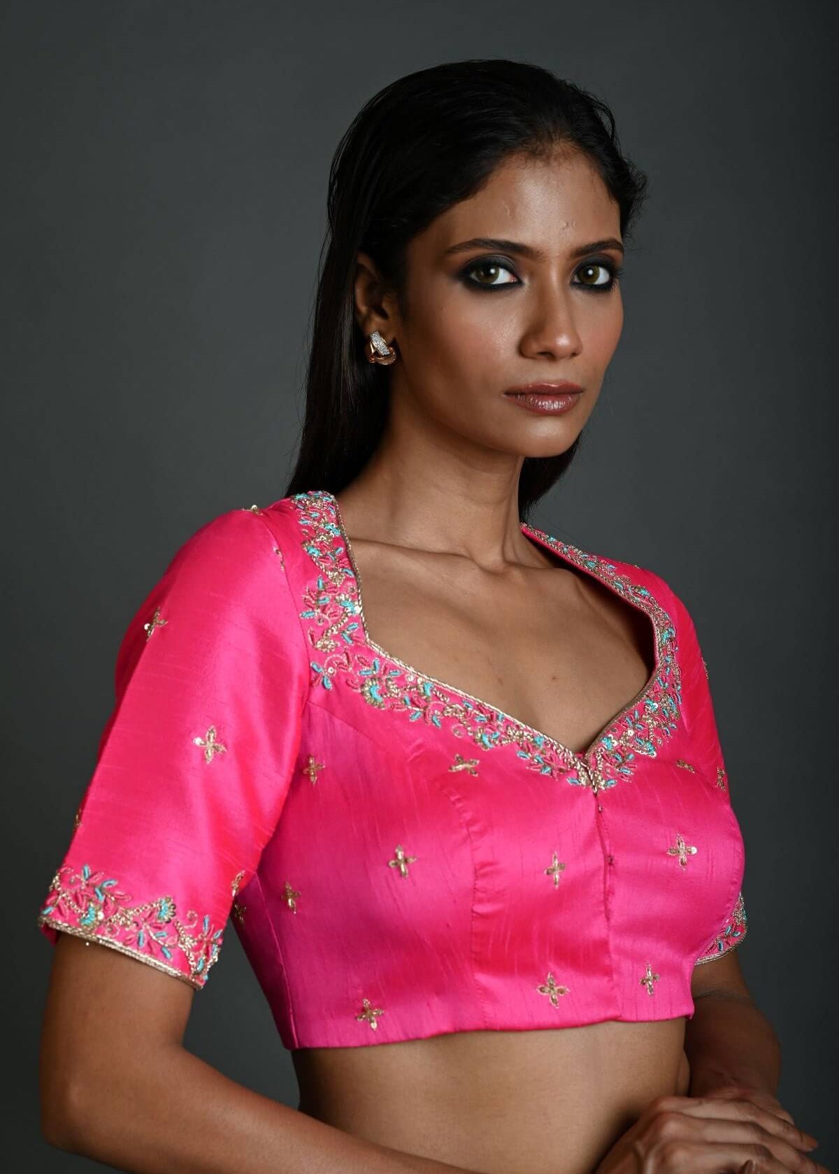 A Woman Wearing a Bright Pink Hand Embroidered Bridal Blouse in Raw Silk with Queen Anne Neckline - Anvi Couture - Image 2