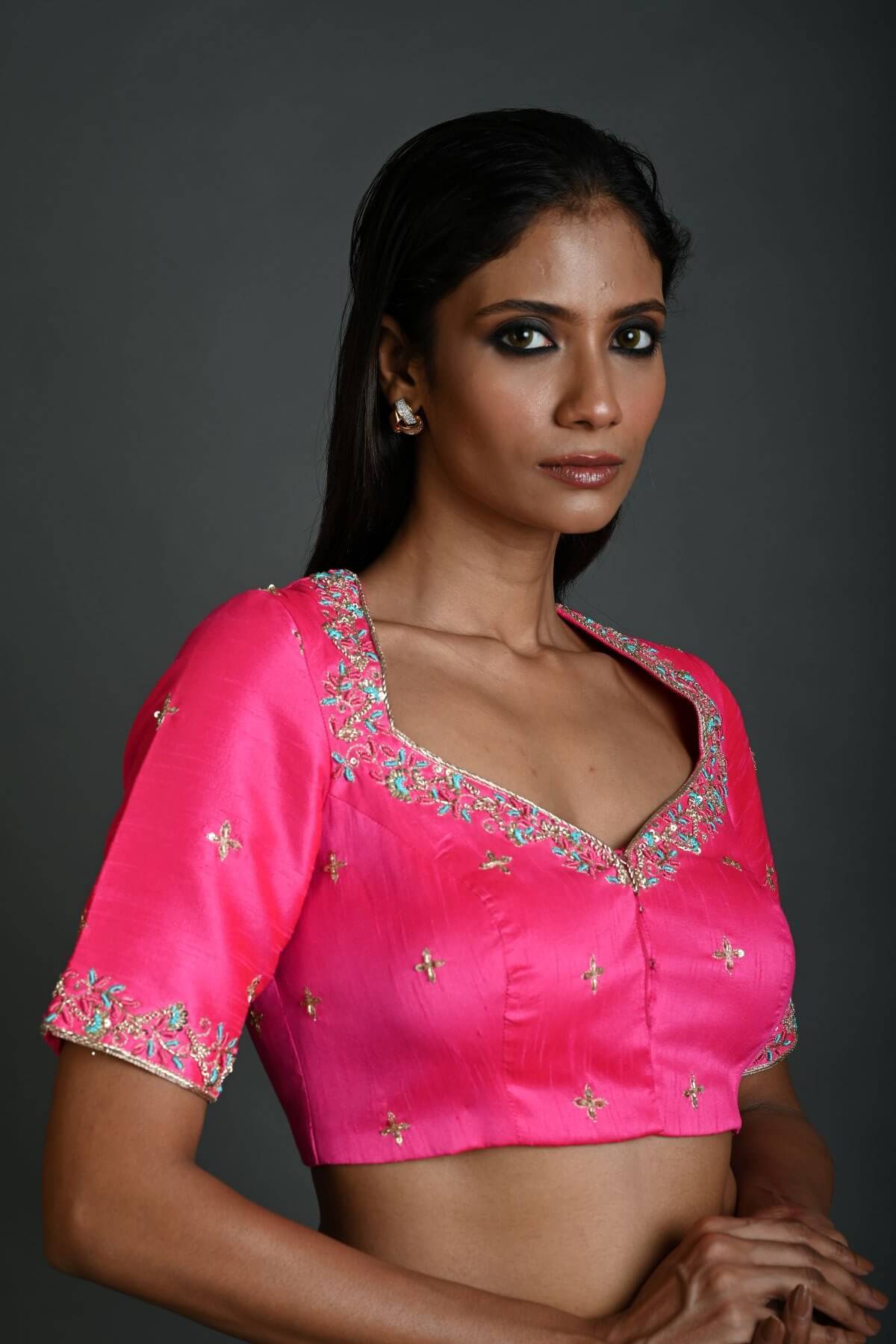 A Woman Wearing a Bright Pink Hand Embroidered Bridal Blouse in Raw Silk with Queen Anne Neckline - Anvi Couture - Image 2