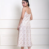 Off-white printed midi dress with a strappy design, perfect for contemporary fashion and day-to-evening transitions.