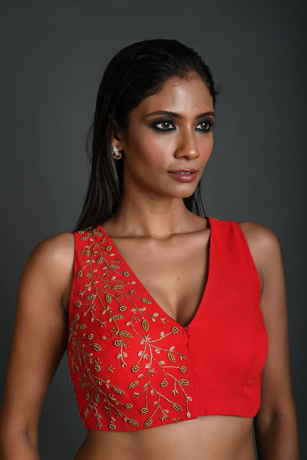 Front view of red hand embroidered sleeveless georgette blouse with V-neckline 