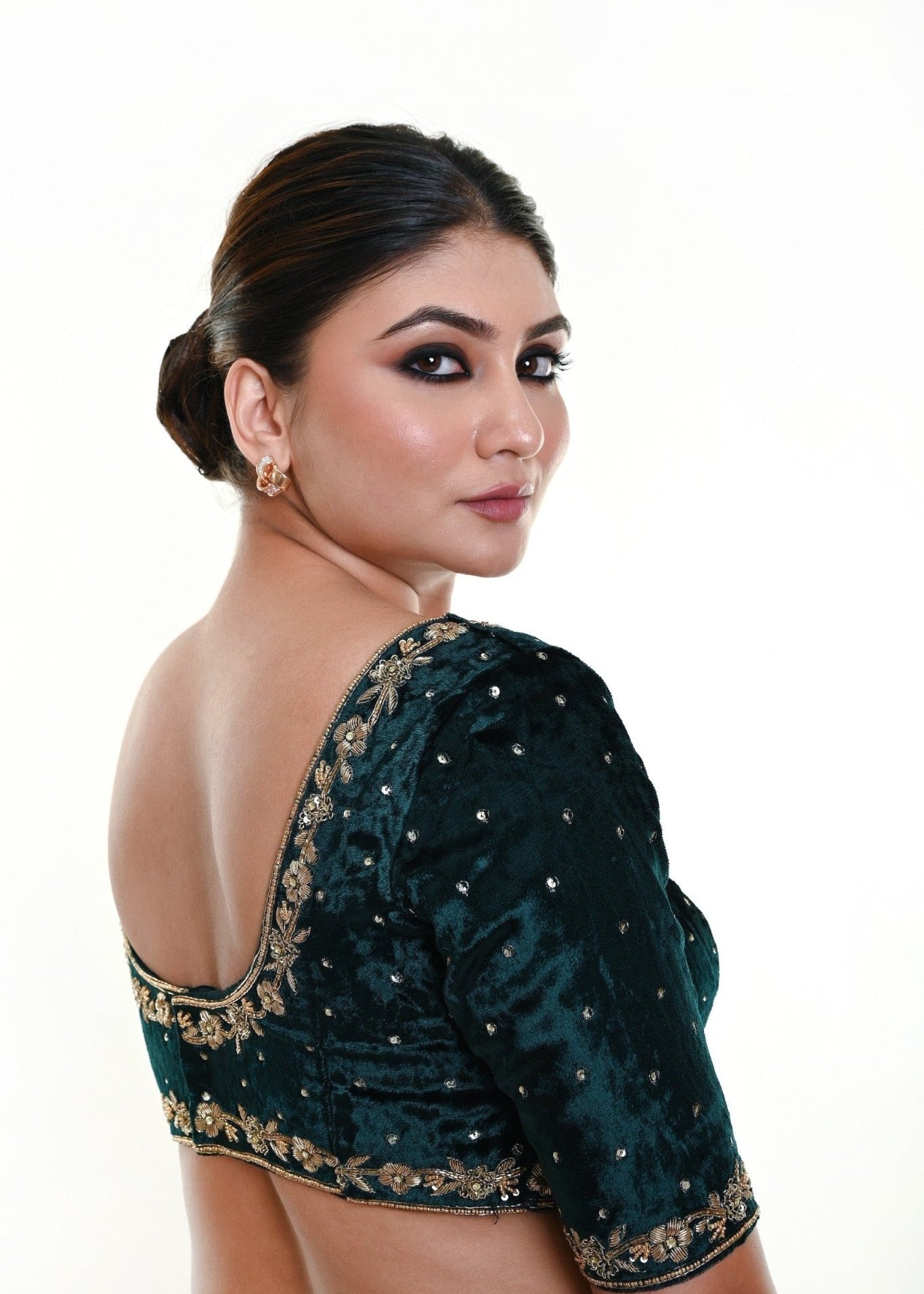 An Indian Bride Dressed in a Bottle Green Velvet Bridal Blouse with Hand Embroidered Zardozi Motifs and Back Closure: Anvi Couture - Image 4