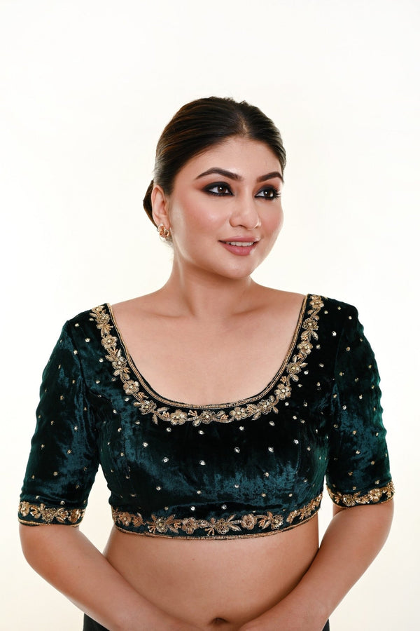 A Woman Wearing a Bottle Green Velvet Bridal Blouse with Hand Embroidered Zardozi Motifs and Back Closure - Bridal Blouse: Anvi Couture - Image 1