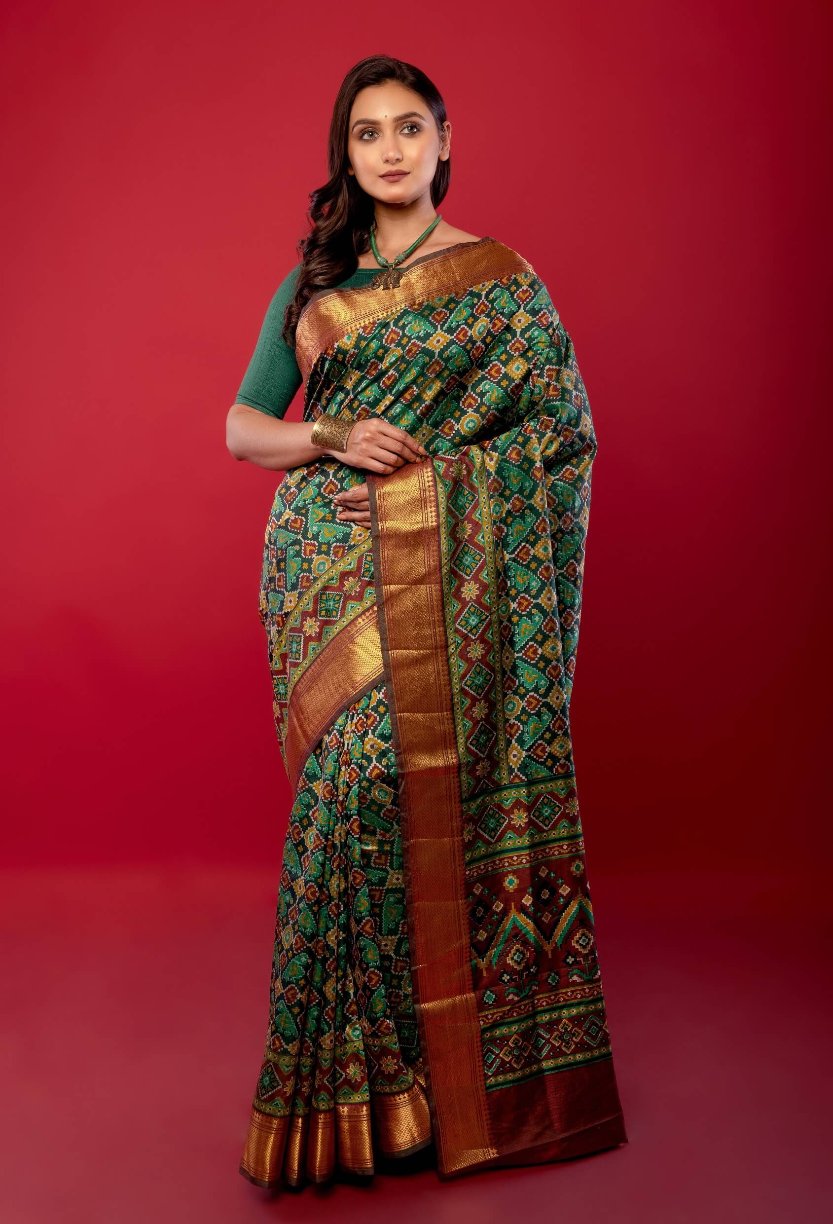 Green Patola Silk Saree with Contrasting Maroon and Gold Zari Border - Anvi Couture
