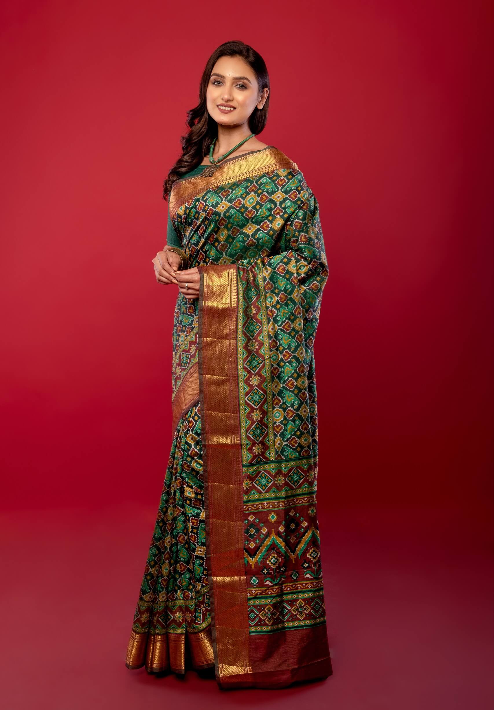 Green Patola Silk Saree with Contrasting Maroon and Gold Zari Border - Anvi Couture