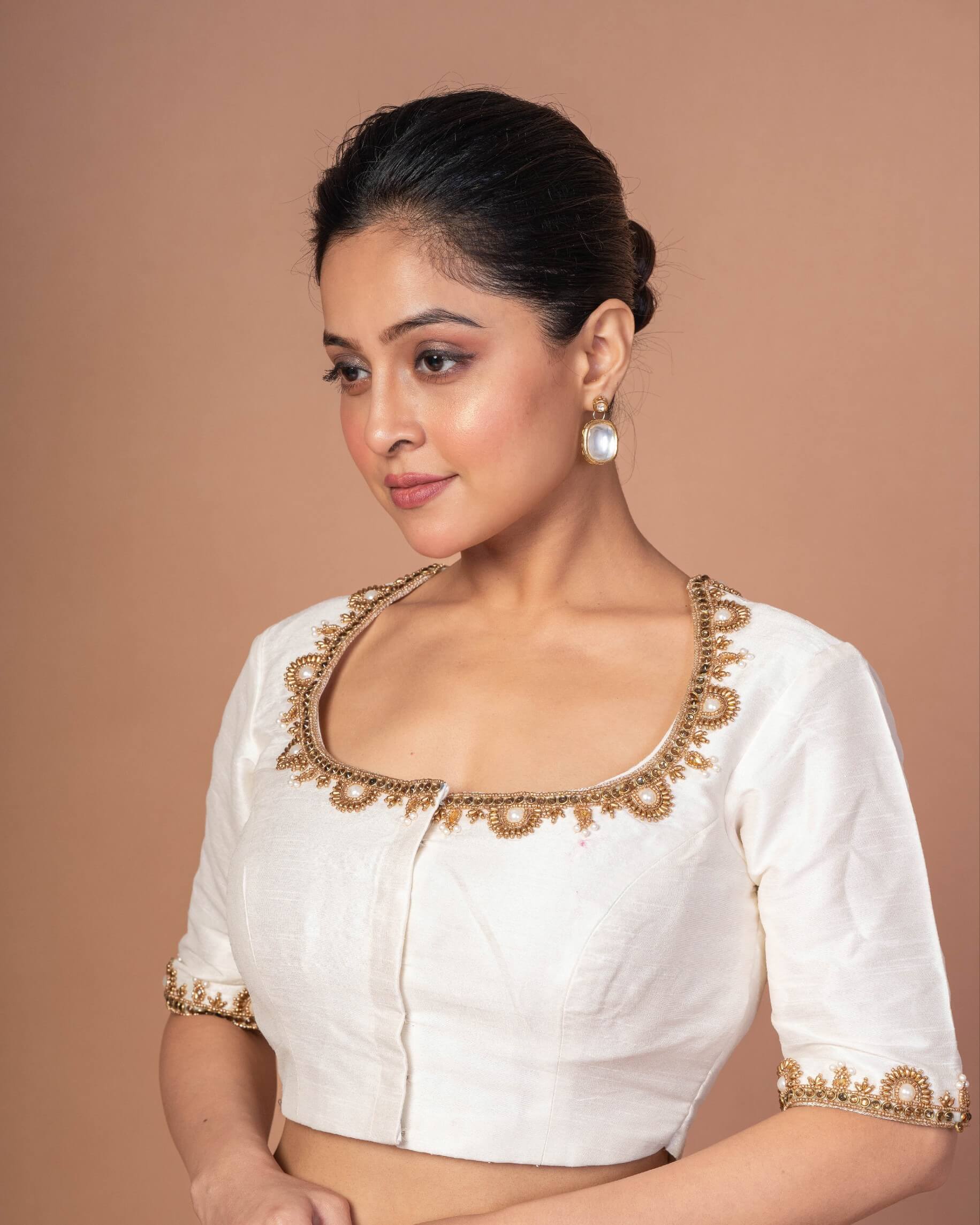 Woman Wearing a White Raw Silk Aari work Embroidered Blouse with Square Neckline - Anvi Couture - Image 2