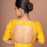 A Woman Wearing a Yellow Raw Silk Blouse with Boat Neckline and Gold Floral Work: Anvi Couture - Image 5