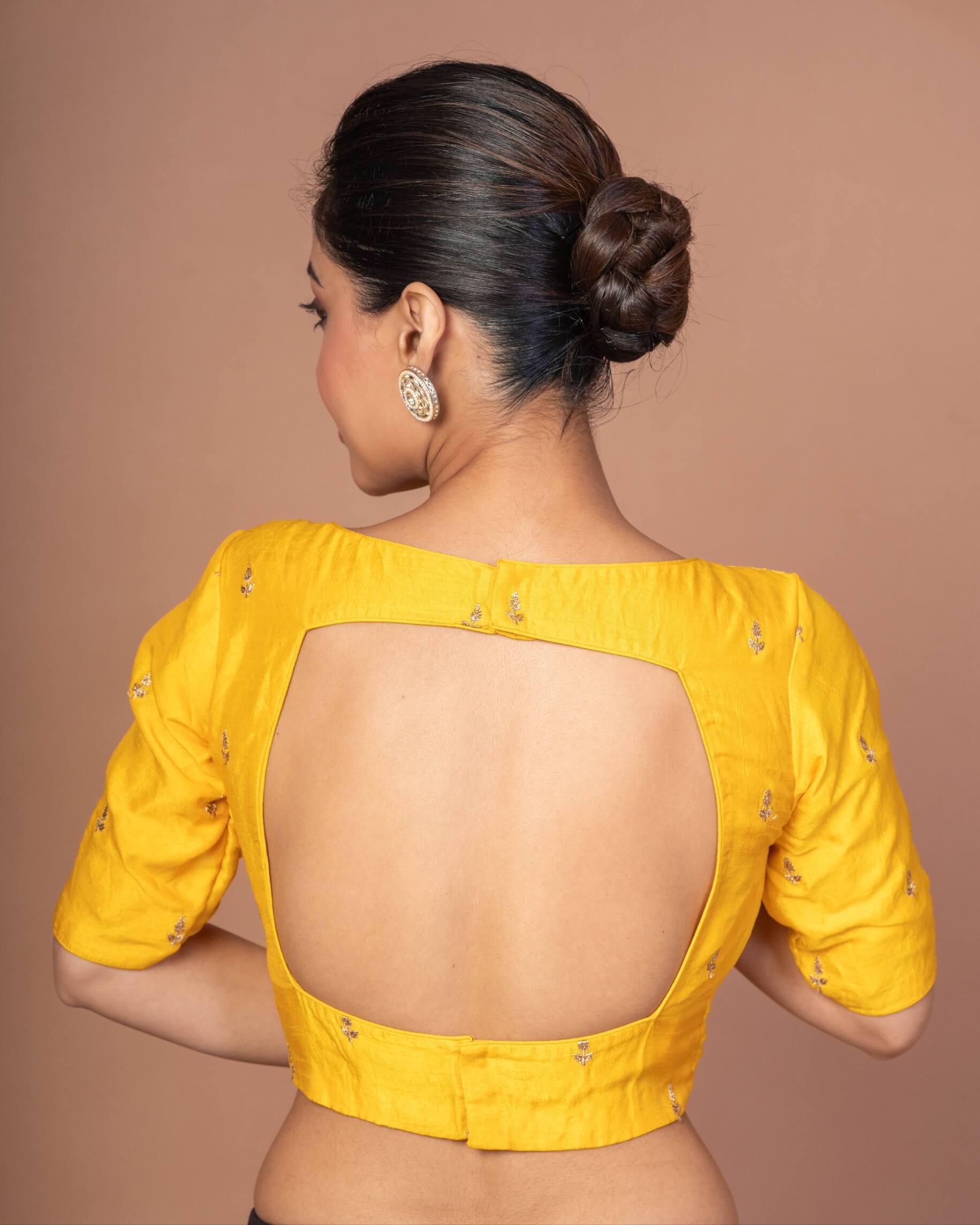 A Woman Wearing a Yellow Raw Silk Blouse with Boat Neckline and Gold Floral Work: Anvi Couture - Image 5