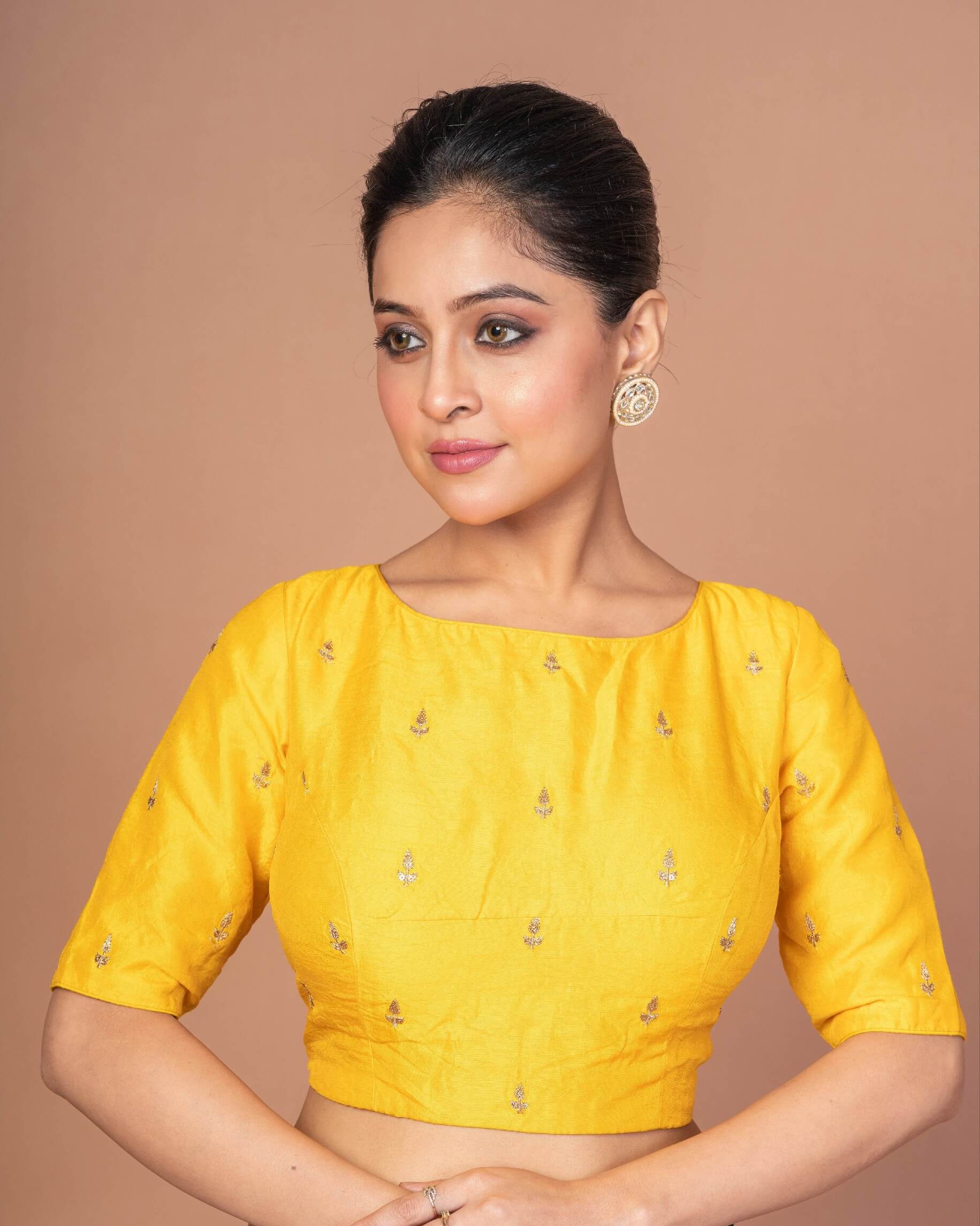 An Indian Woman Dressed in a Yellow Raw Silk Blouse with Boat Neckline and Gold Floral Work: Anvi Couture - Image 2