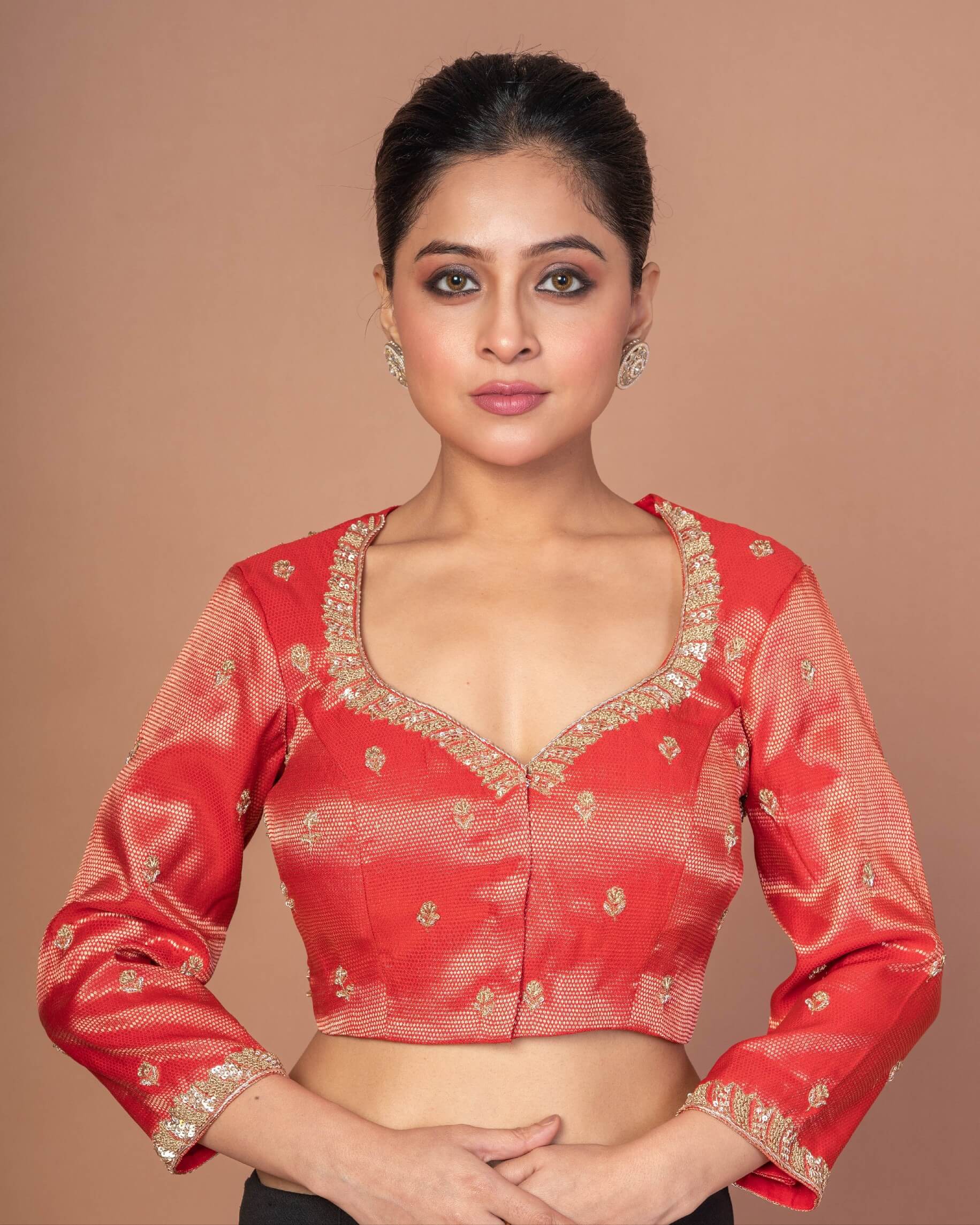 Woman Wearing a Red Tissue Silk Blouse with Hand Embroidered Work: Bridal Blouse - Anvi Couture - Image 1