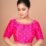 Woman Wearing a Hot Pink Hand Embroidered Blouse in Raw Silk with Boat Neckline and Back cutout: Party Wear Blouse - Anvi Couture - Image 1