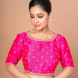 Woman Wearing a Hot Pink Hand Embroidered Blouse in Raw Silk with Boat Neckline and Back cutout: Party Wear Blouse - Anvi Couture - Image 1