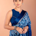 Back view of blue floral georgette saree showing draped pallu and blouse