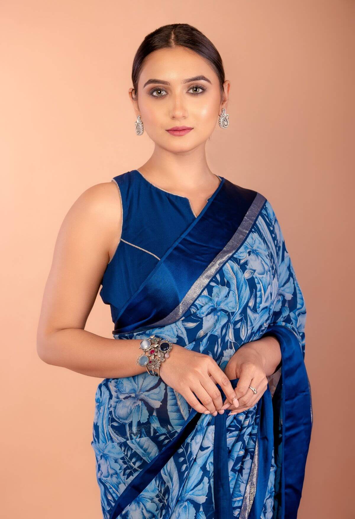 Back view of blue floral georgette saree showing draped pallu and blouse