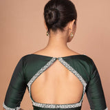 Back view of dark green silk blouse showing pearl-studded cut-out back design