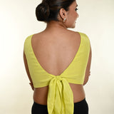 Back view of lemon yellow satin blouse with decorative bow tie-up detail - Anvi Couture