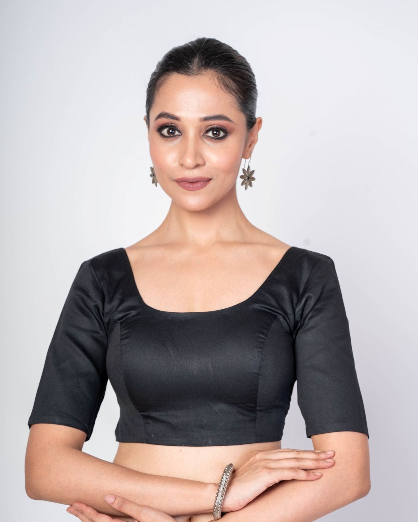 Minimalist black cotton silk blouse with a classic U-neck and half sleeves for an elegant saree look