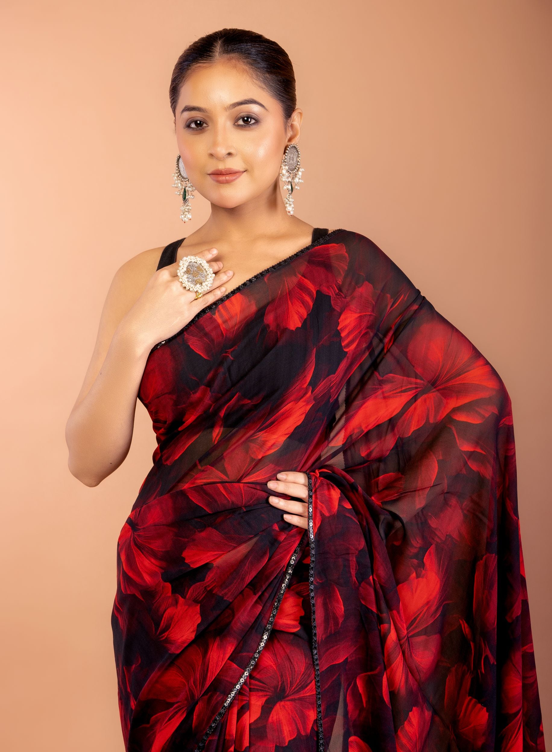 Black and Red Georgette Printed Saree With Sequin Border Close Up
