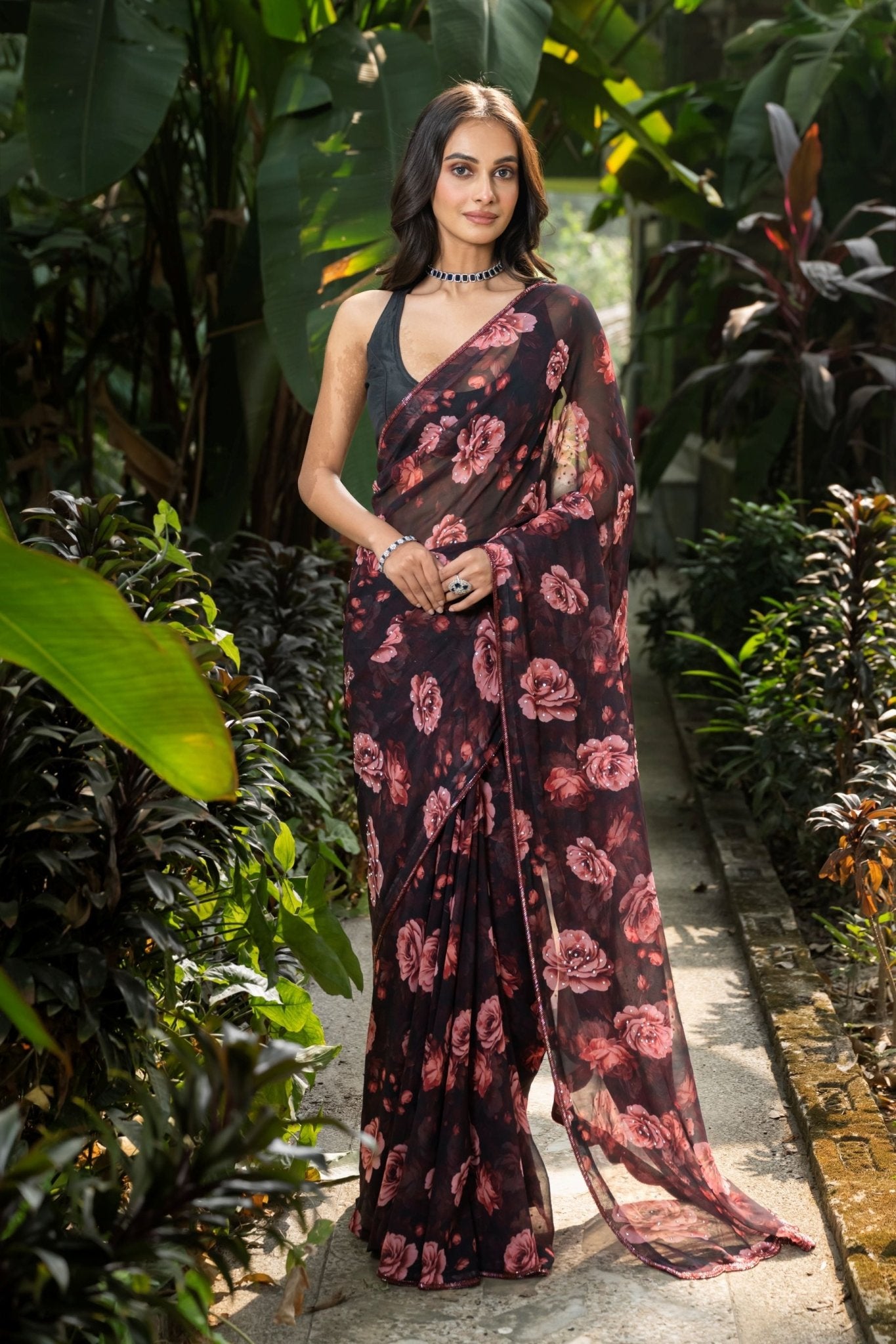 Black georgette saree with rose prints and stone embellishment — front drape view, Anvi Couture
