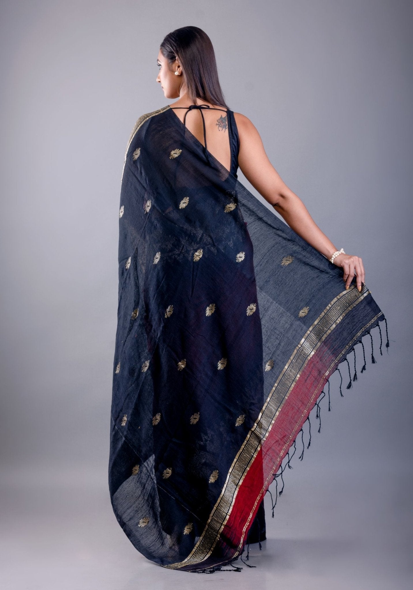 Black saree blouse paired with red ombre Tant Jamdani party wear - Back
