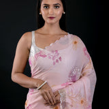 Close-up of floral embroidery and cutwork detail on light pink georgette saree by Anvi Couture