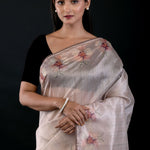 Close-up of floral embroidery detail on pearl white tissue silk saree, Anvi Couture - Front 3