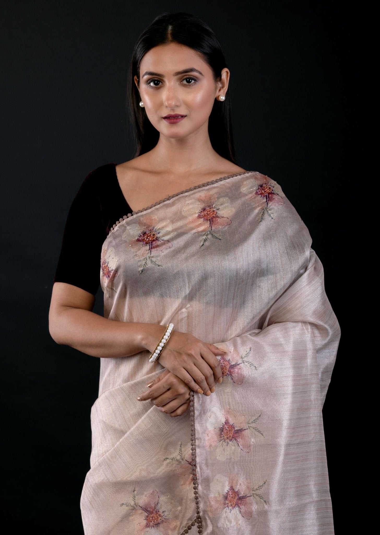 Close-up of floral embroidery detail on pearl white tissue silk saree, Anvi Couture - Front 3