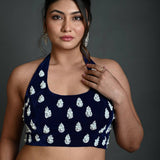 Close-up of hand embroidery work on navy blue velvet halter neck blouse
