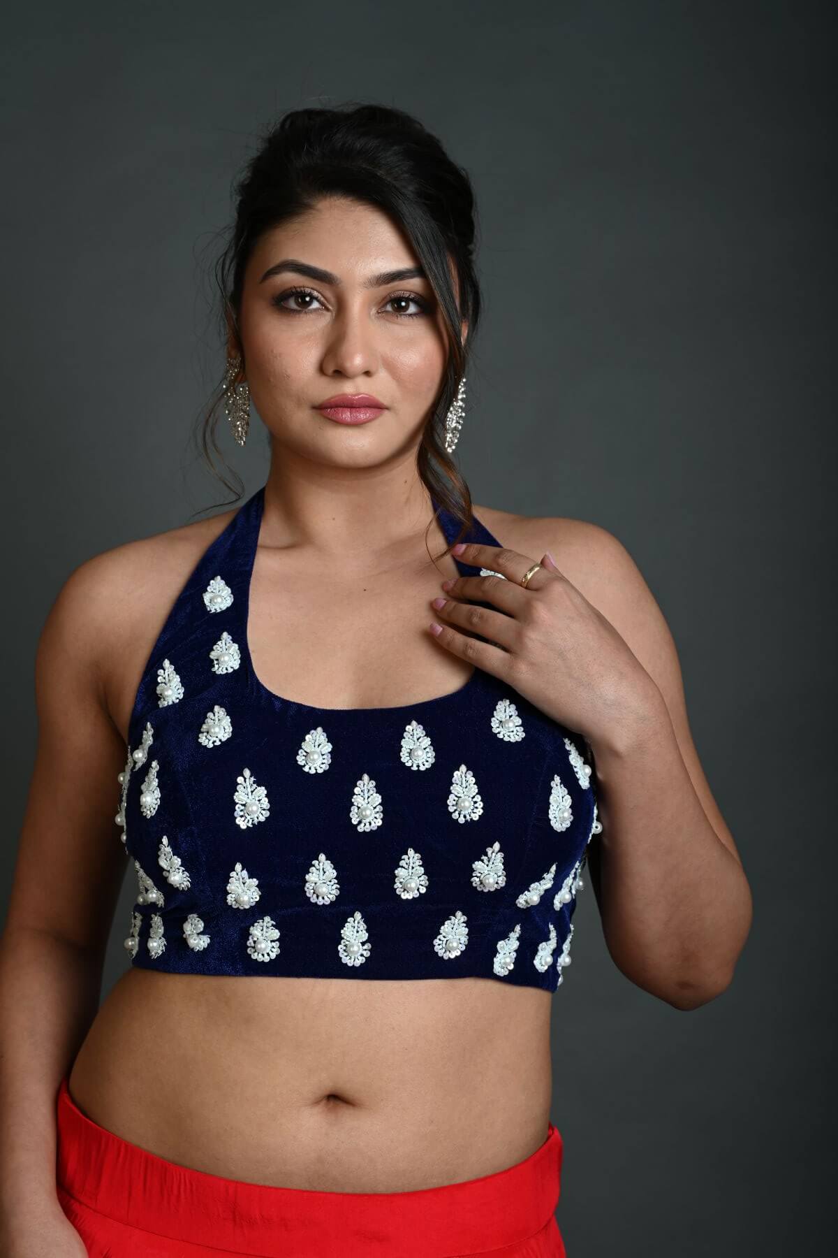 Close-up of hand embroidery work on navy blue velvet halter neck blouse