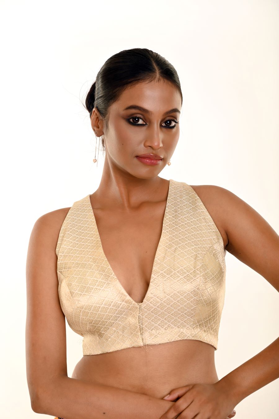 Close-up of pearl white brocade weave and V-neckline edge