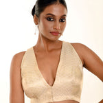 Close-up of pearl white brocade weave and V-neckline edge