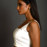 Close-up of square neckline design on white sleeveless cotton blouse