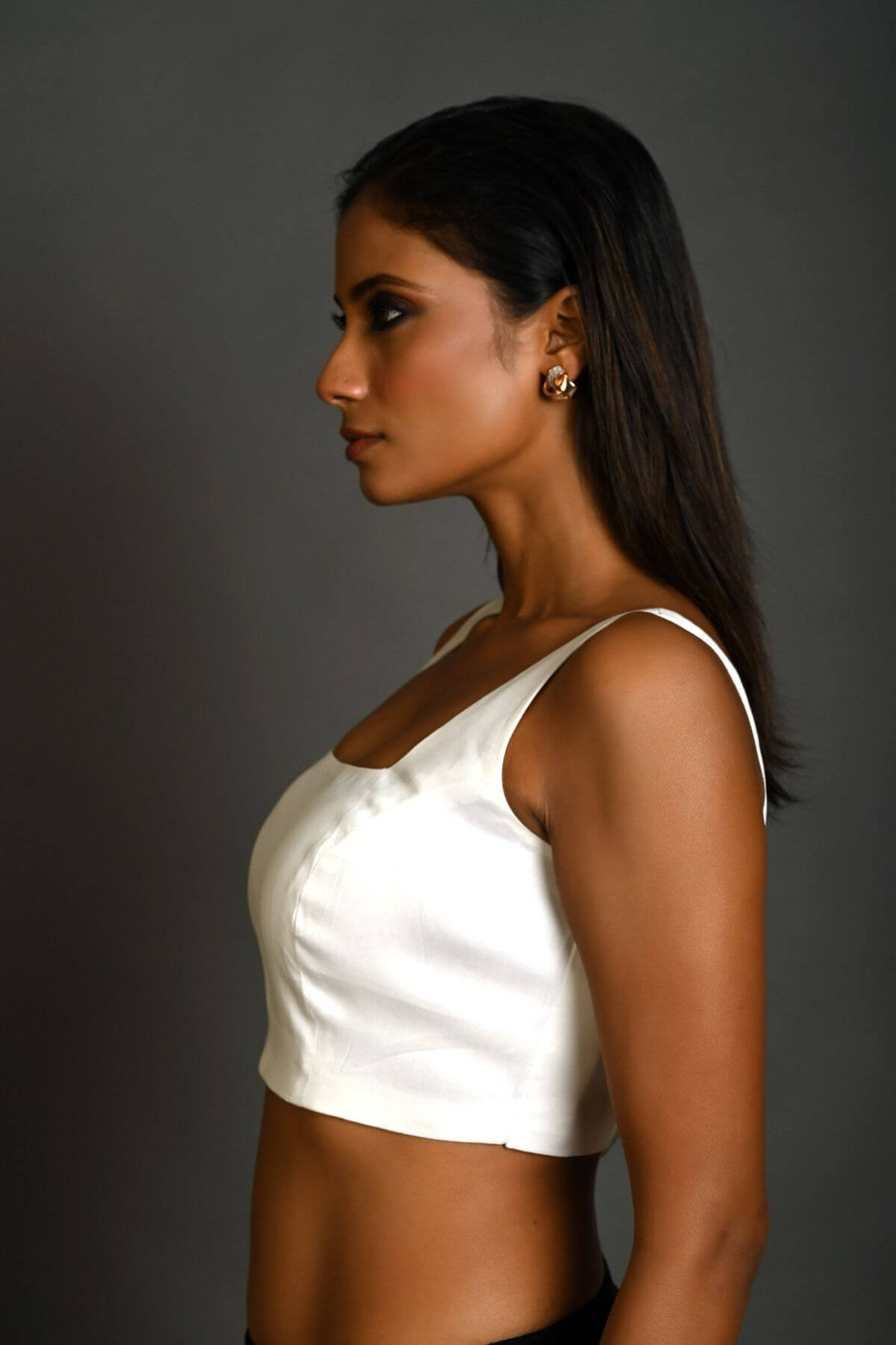 Close-up of square neckline design on white sleeveless cotton blouse