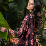 Close-up of stone embellishment and rose print on black georgette saree by Anvi Couture