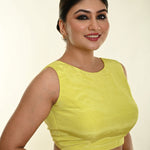 Close-up of the back bow tie on lemon yellow satin sleeveless blouse
