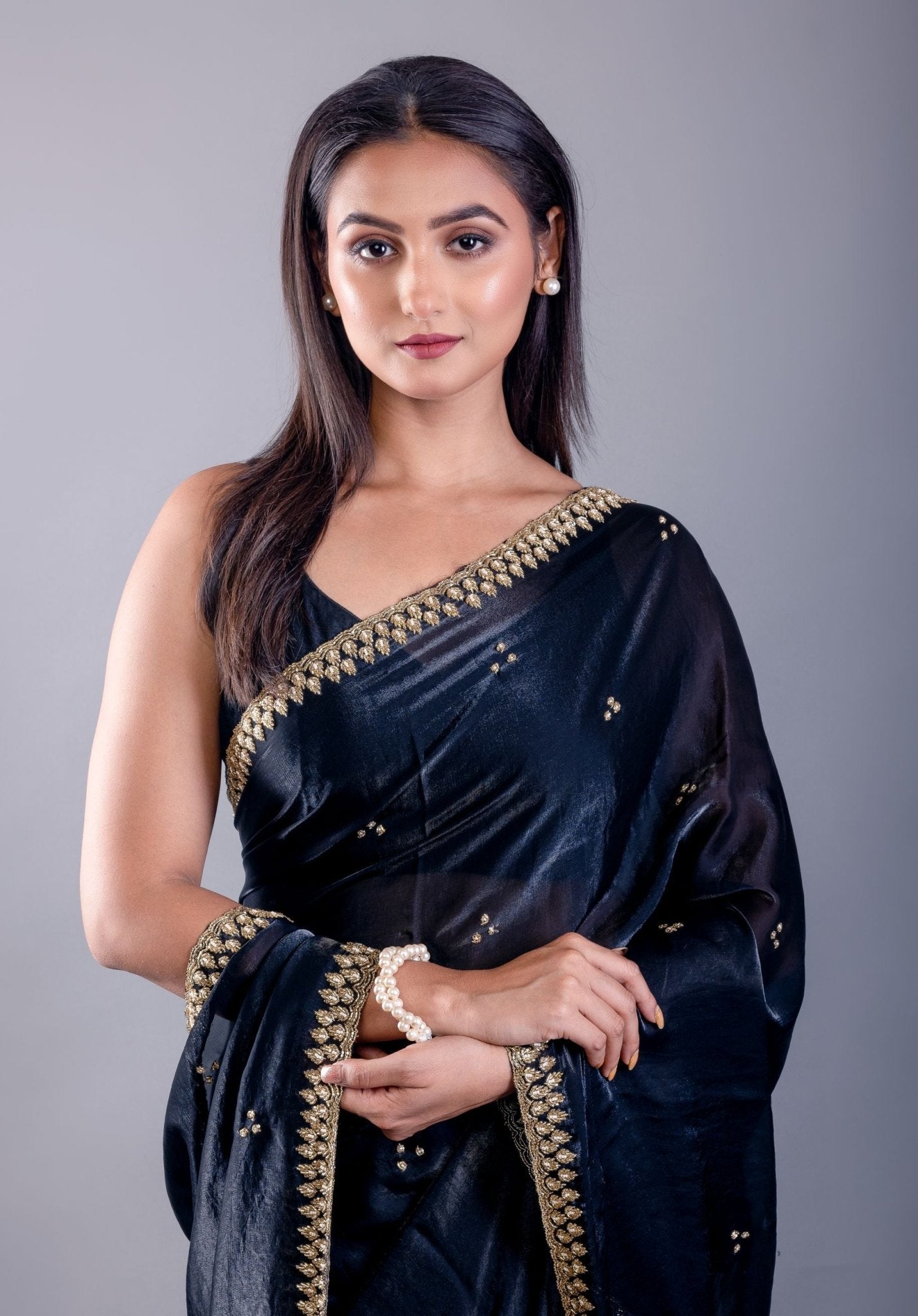 Deep blue satin silk saree — drape view highlighting hand-embroidered cutdana embellishment on body