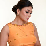 Detail of hand embroidery work on butter yellow crepe silk blouse — close-up 
