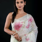 Detail view of embroidered border and floral print on light green georgette saree by Anvi Couture