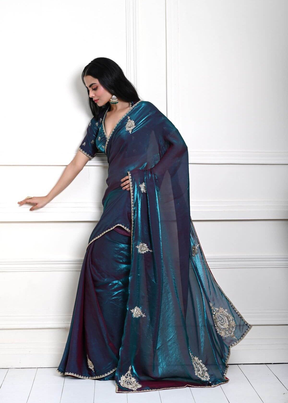 Detailed view of embroidered border on teal blue organza silk saree