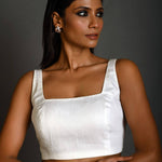 Front view of white sleeveless cotton blouse with square neckline