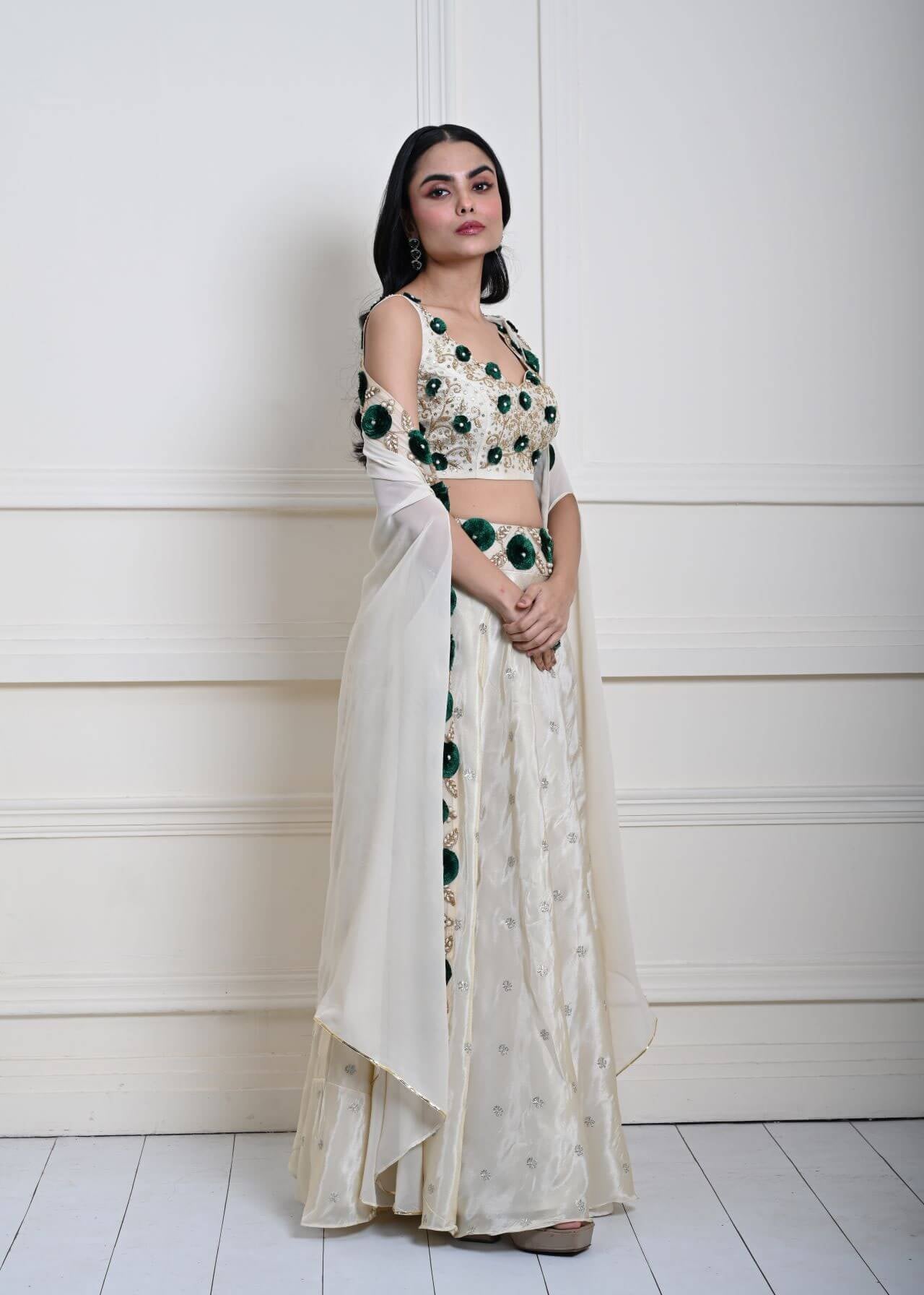 Ivory cape lehenga in tissue silk — side profile showing hand-embroidered bodice detail