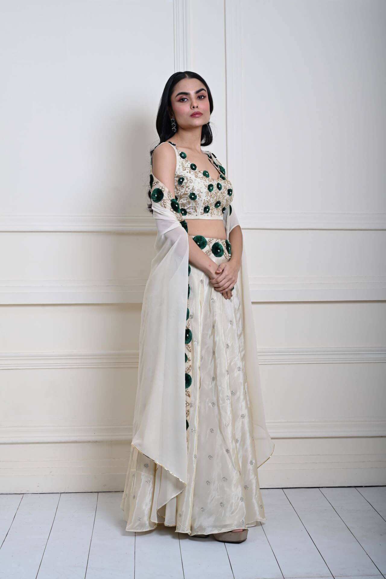 Ivory cape lehenga in tissue silk — side profile showing hand-embroidered bodice detail
