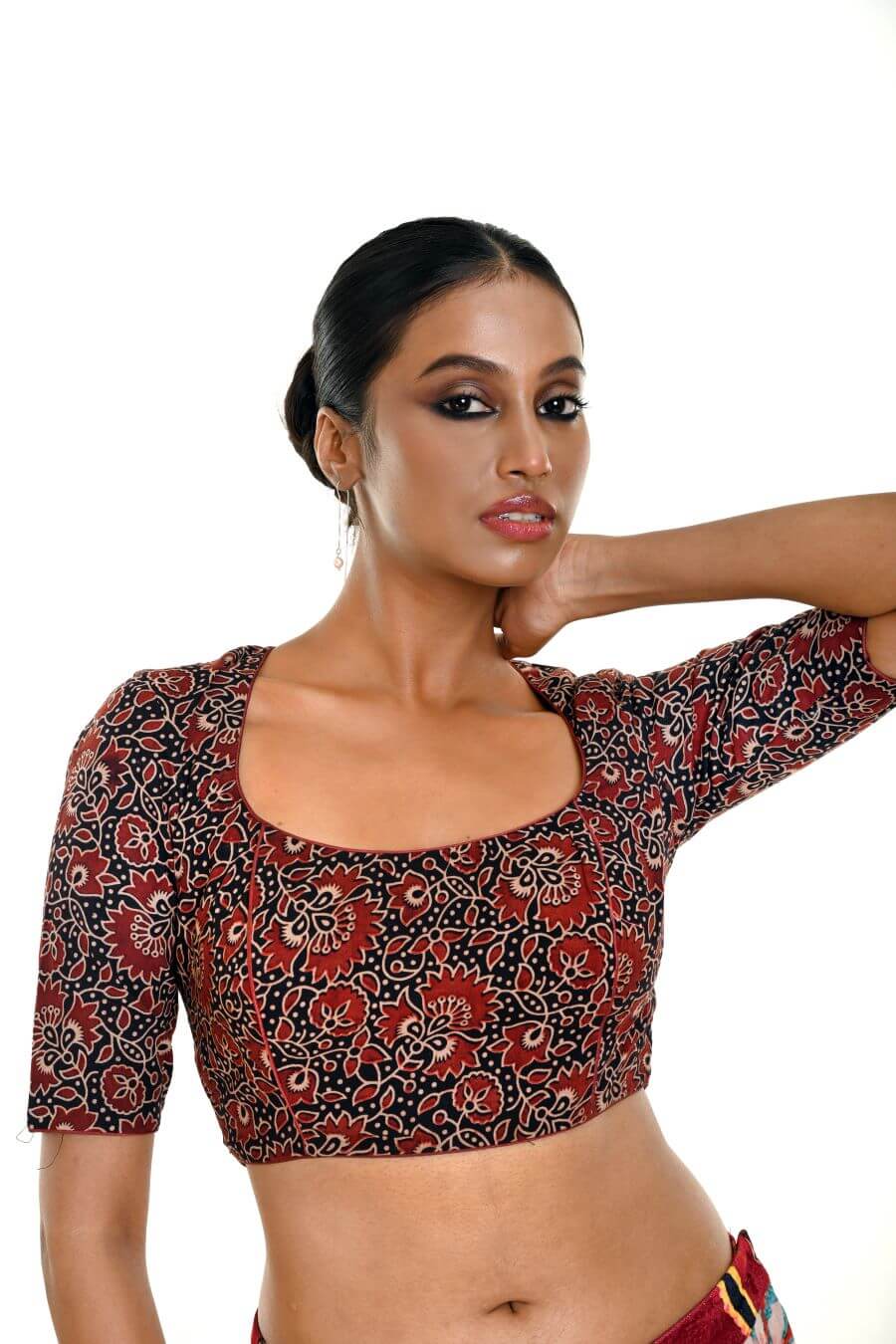 Close-up of handcrafted maroon and black Ajrakh print pure cotton saree blouse with ethnic design